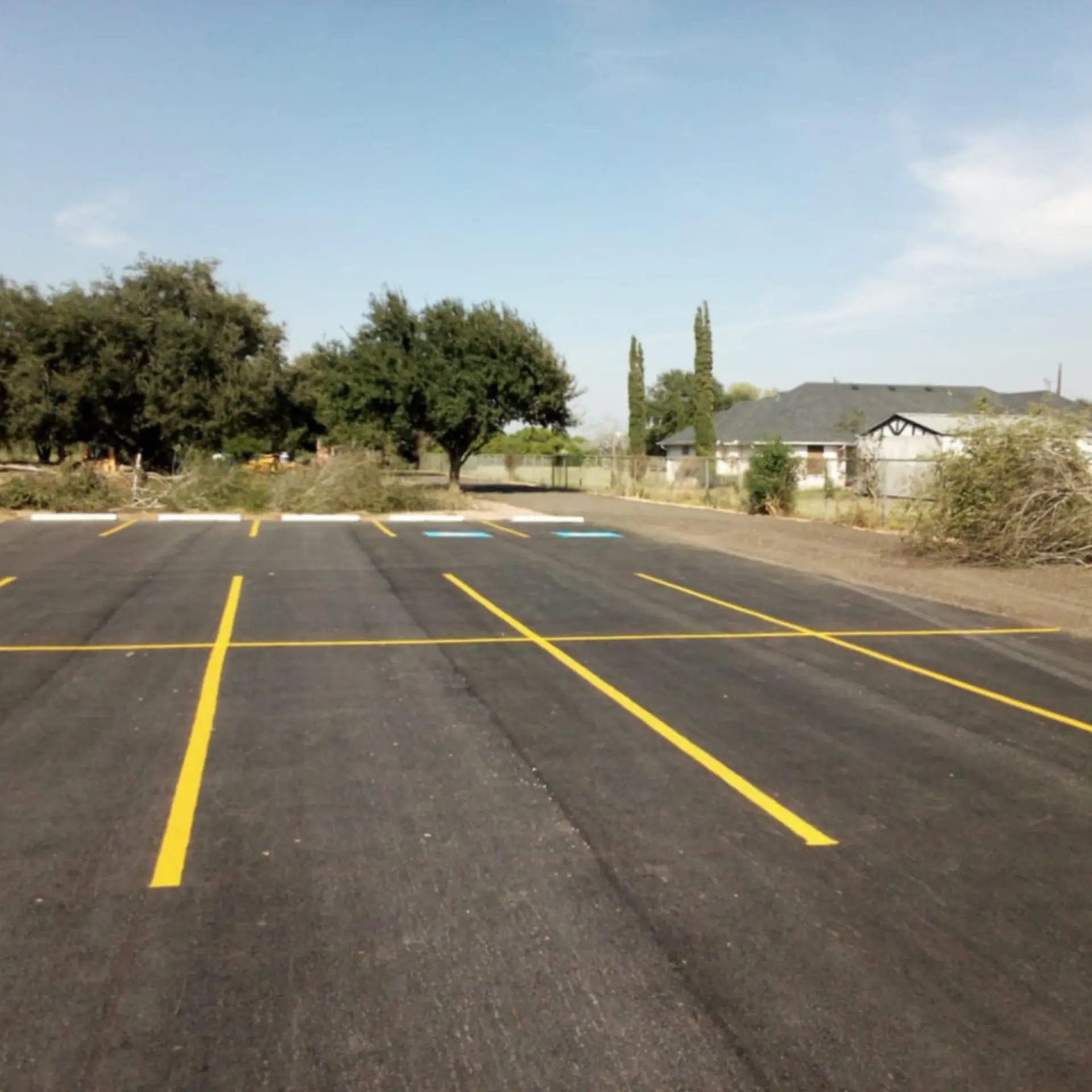 Freshly paved and striped parking lot with marked accessible spaces